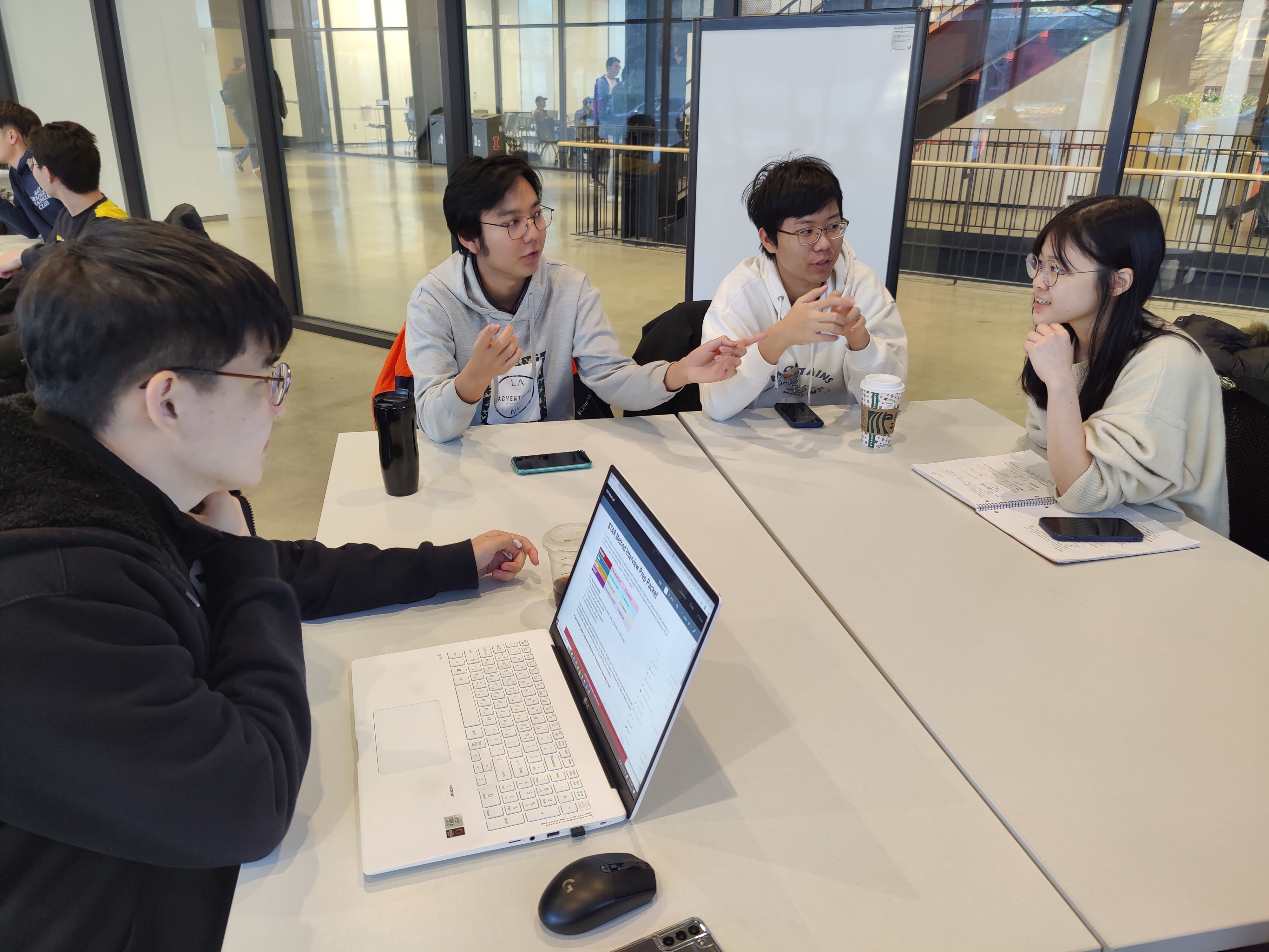 A group of international students sitting around a table during a career certificate workshop