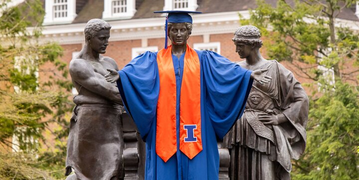 Alma mater statue wearing graduation regalia